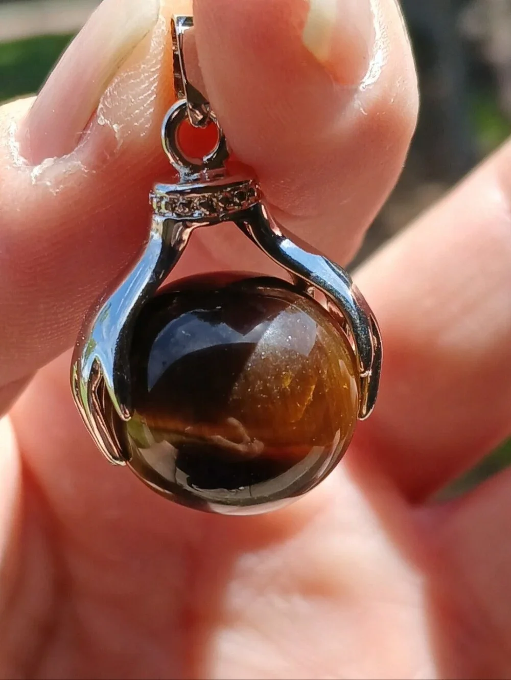 New 18K Hands Holding Tiger Eye Sphere Pendant.